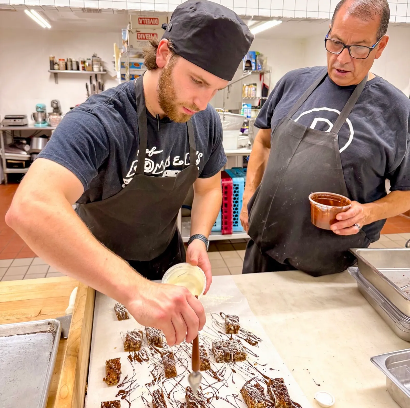 Rex and Rommel Hernandez working together in the kitchen