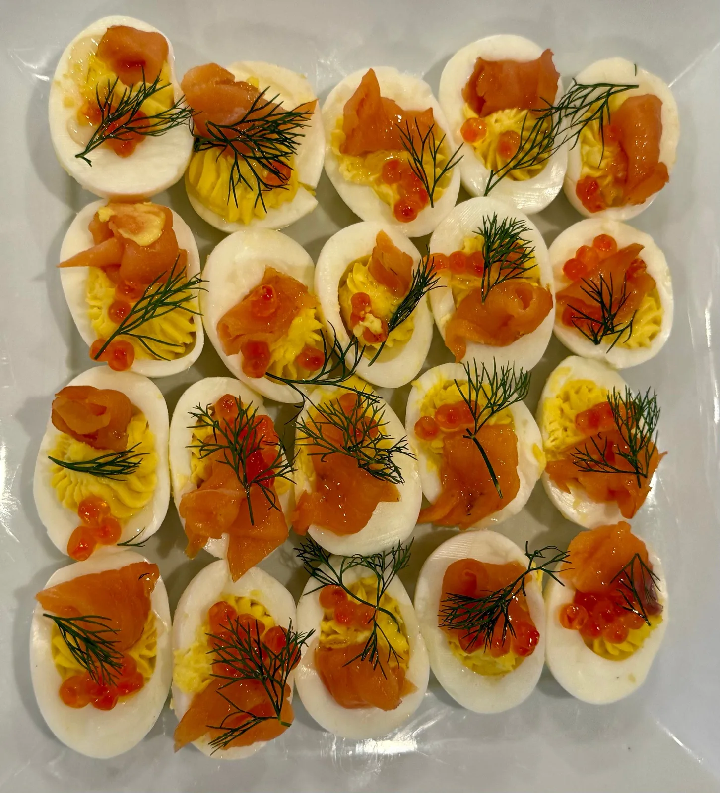 Deviled eggs topped with smoked salmon, roe, and fresh dill