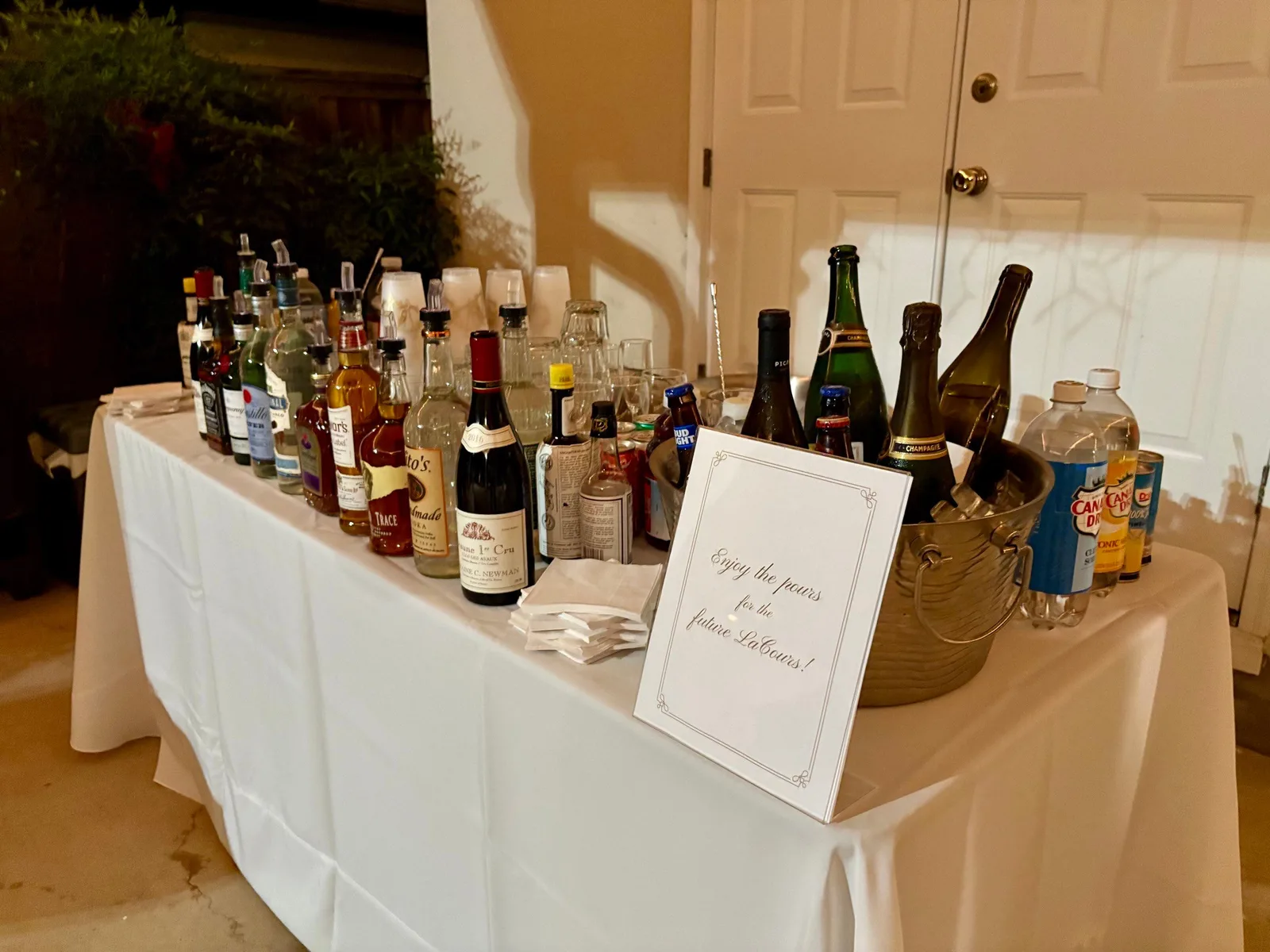 Full bar setup with spirits, wine, and champagne at a private event