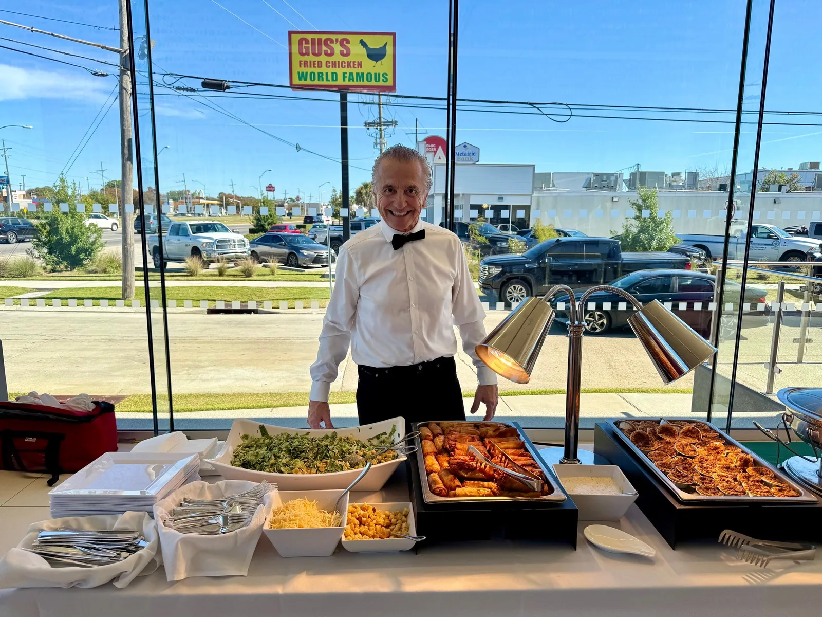 Team member standing behind a hot buffet station at a corporate event