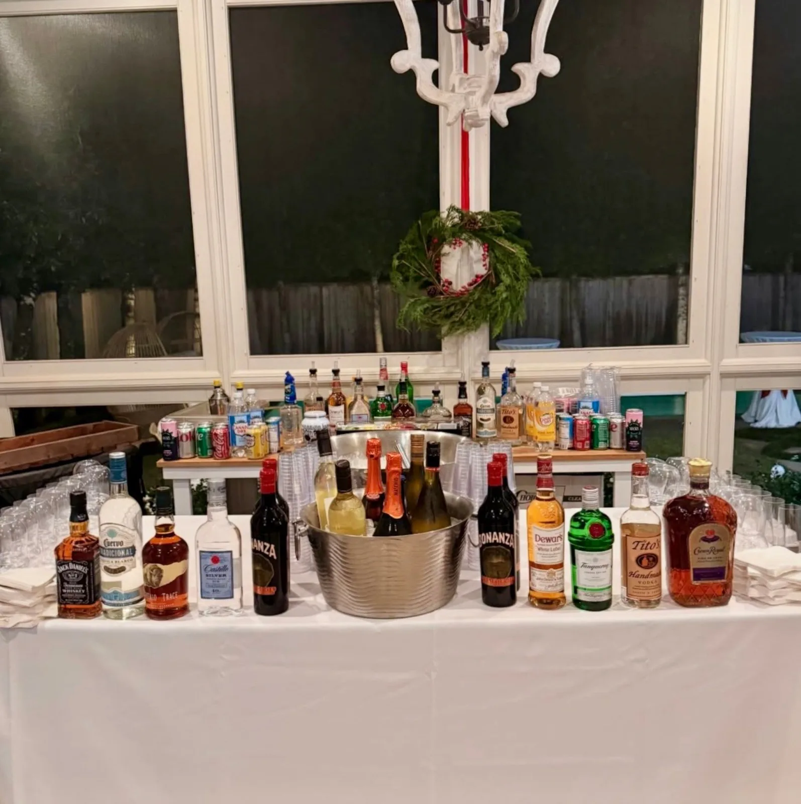 Holiday bar station with bourbon, vodka, wine, and a Christmas wreath