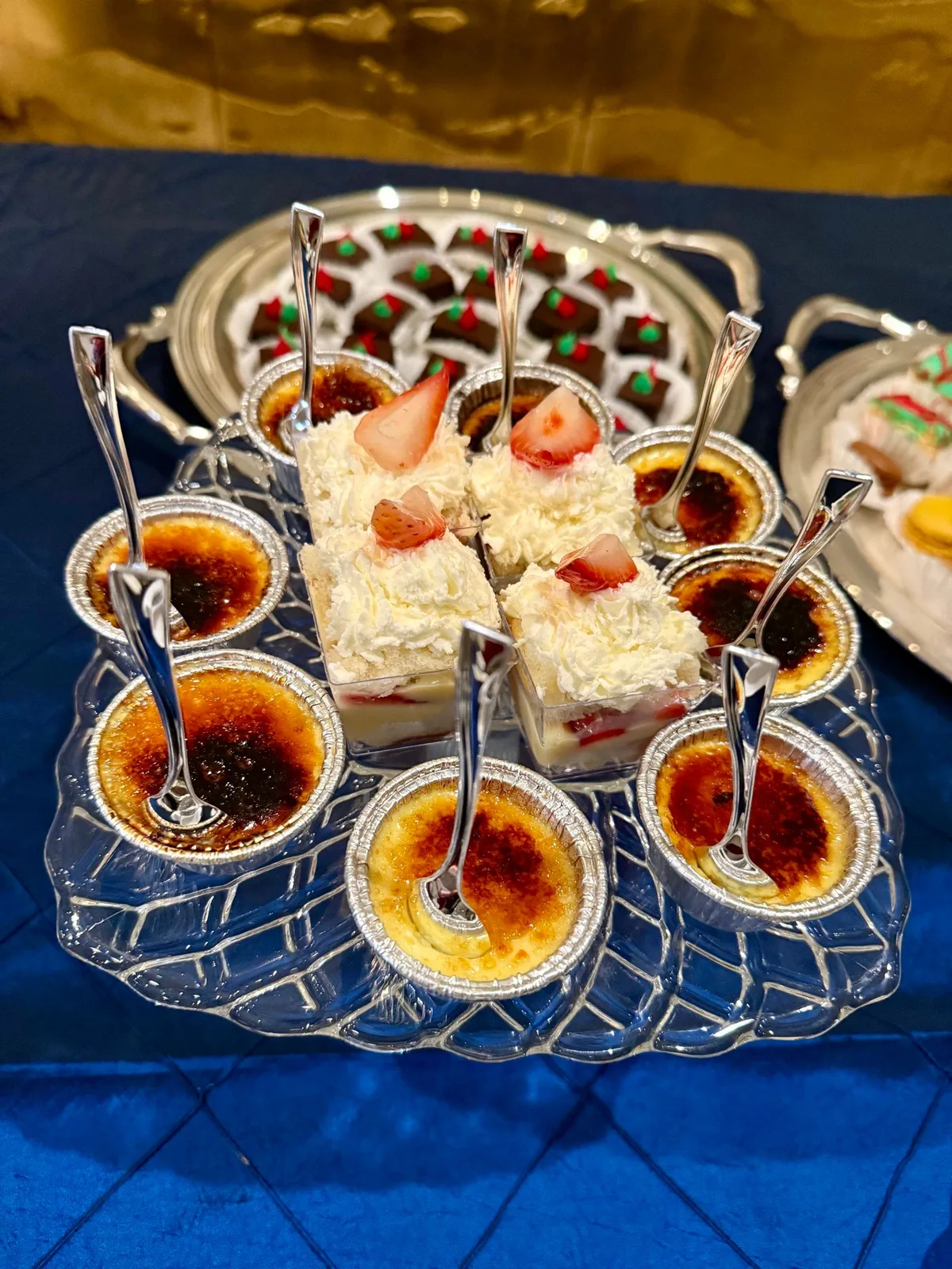 Crème brûlée cups and strawberry shortcake parfaits on a crystal dessert tray