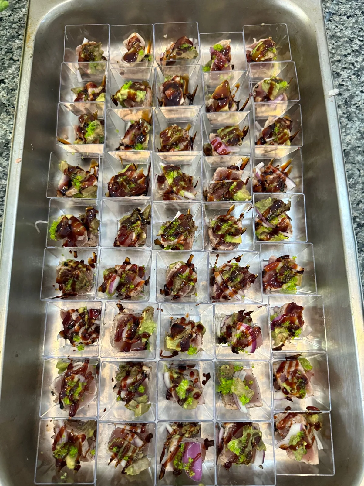 Tuna tataki bites with avocado and balsamic drizzle in individual tasting cups