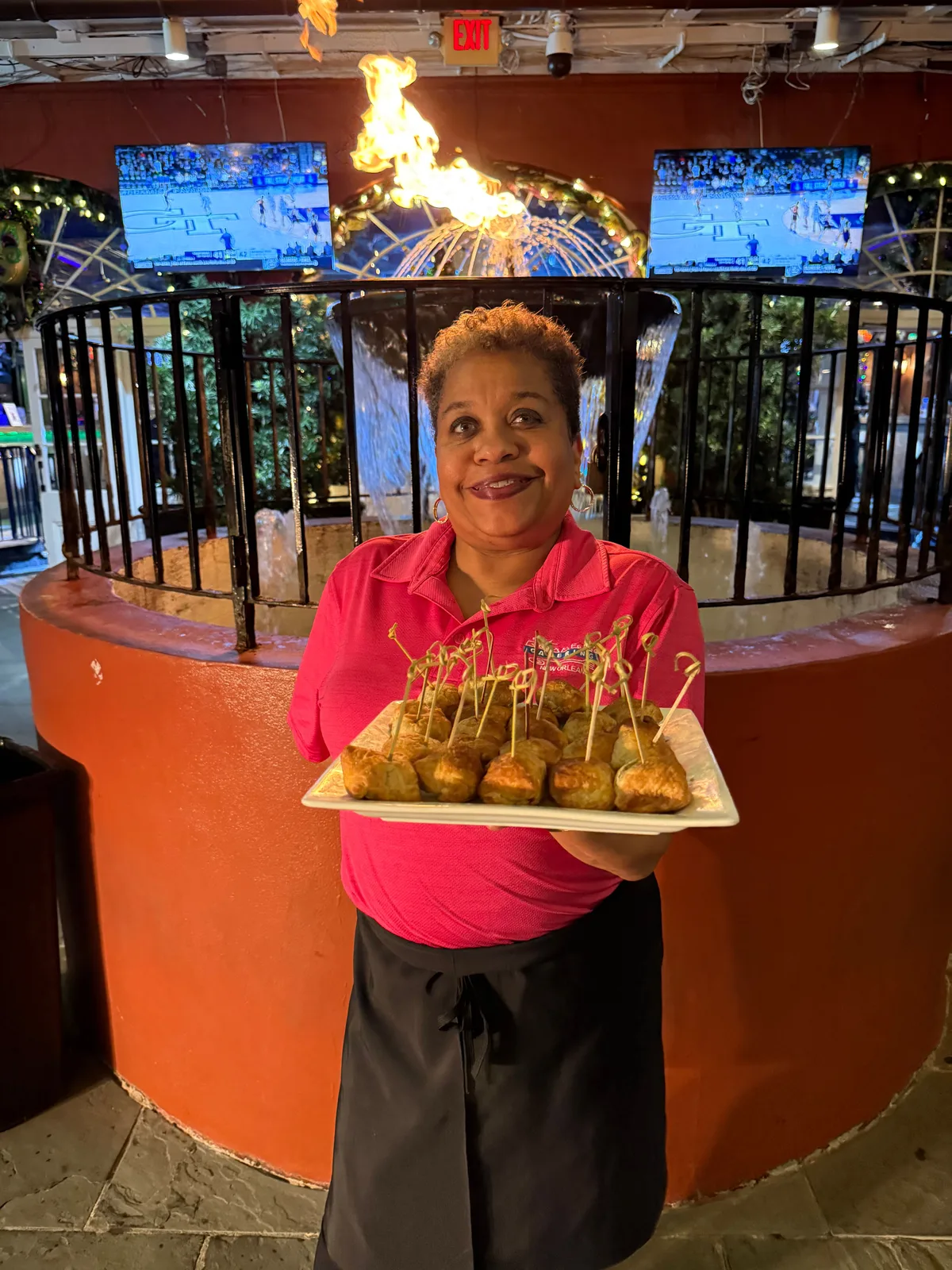 Team member presenting appetizer tray at an outdoor catered event